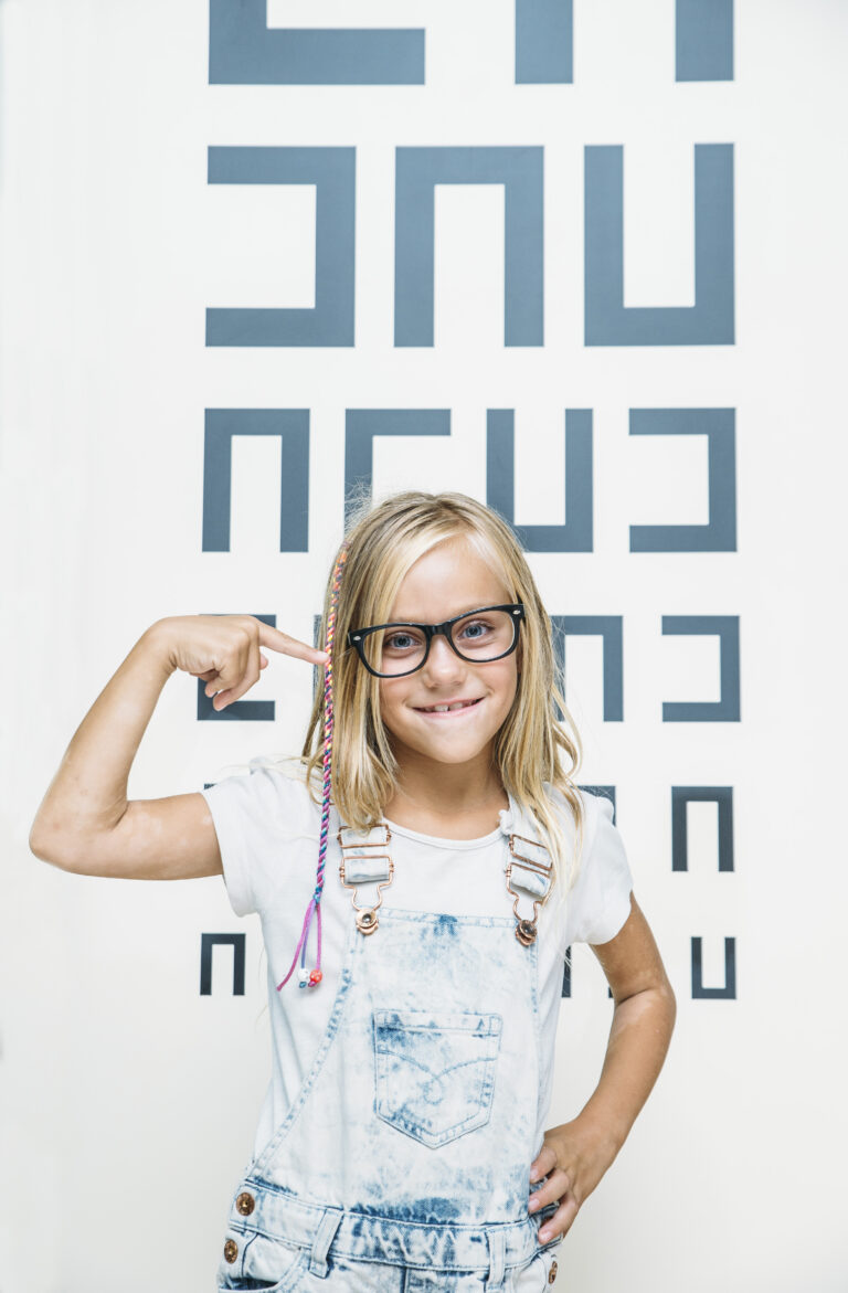 concept vision testing. child girl with eyeglasses