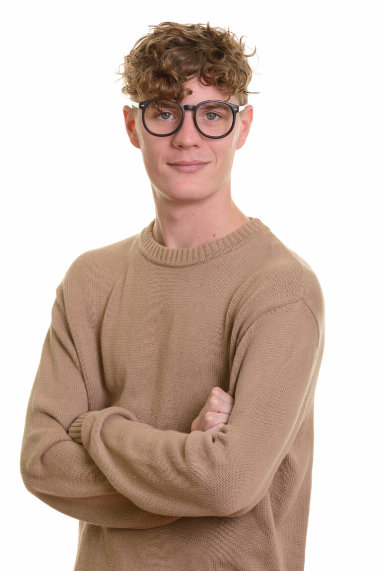 Studio shot of young handsome man with curly blond hair isolated against white background